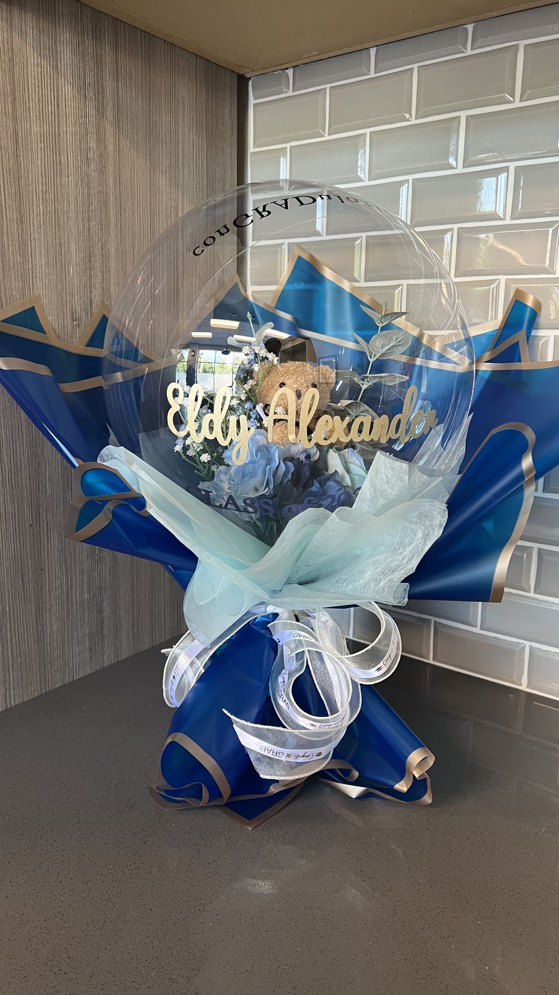 Blue graduation bobo bouquet with personalized name lettering