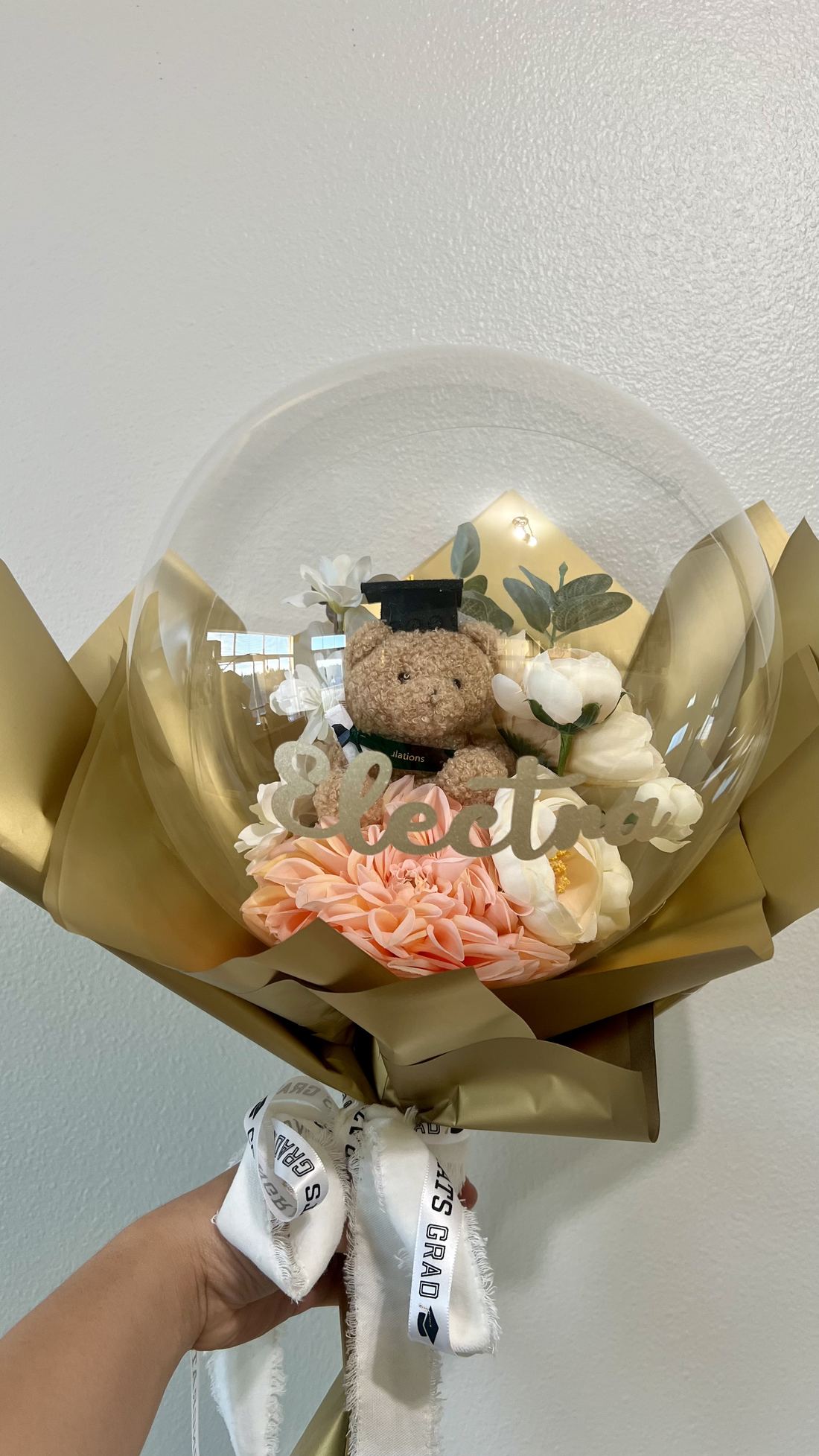 Gold graduation bobo balloon with silk florals and plush bear